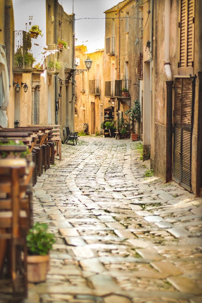 Explore the quaint cobblestone streets of Scicli, Sicily, lined with ancient architecture and Mediterranean charm.