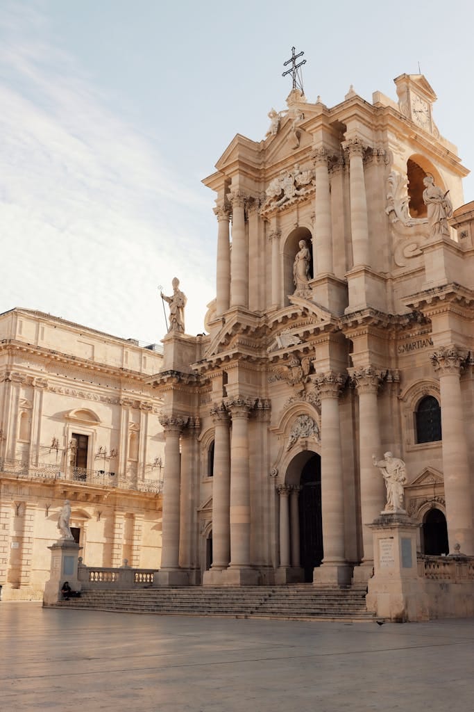 Stunning view of the Baroque façade of Syracuse Cathedral in Sicily, highlighting intricate sculptures and historic design.