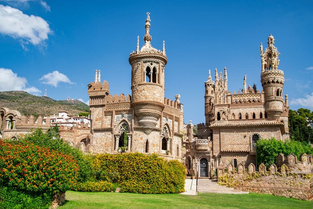 Stunning view of Colomares Monument against a blue sky in Benalmádena, Spain.